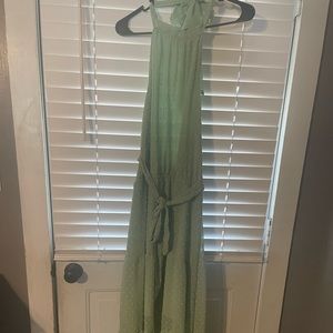 Green high neck, short under shirt with long shirt over. Halter with open back.